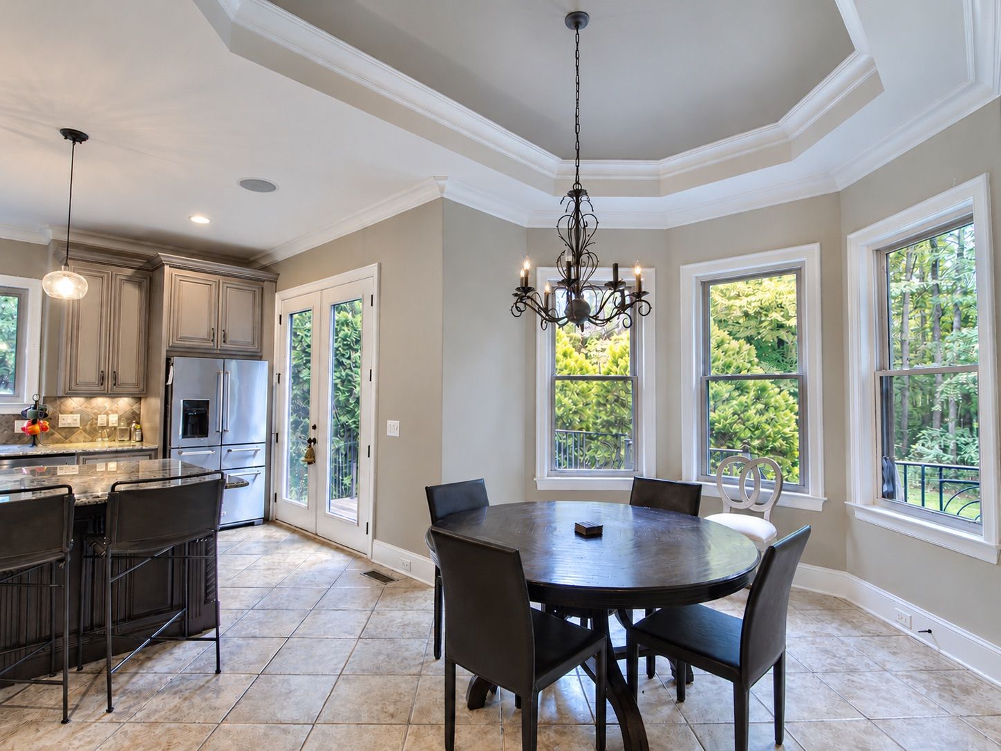 Breakfast nook with bay windows and chandelier beside the kitchen