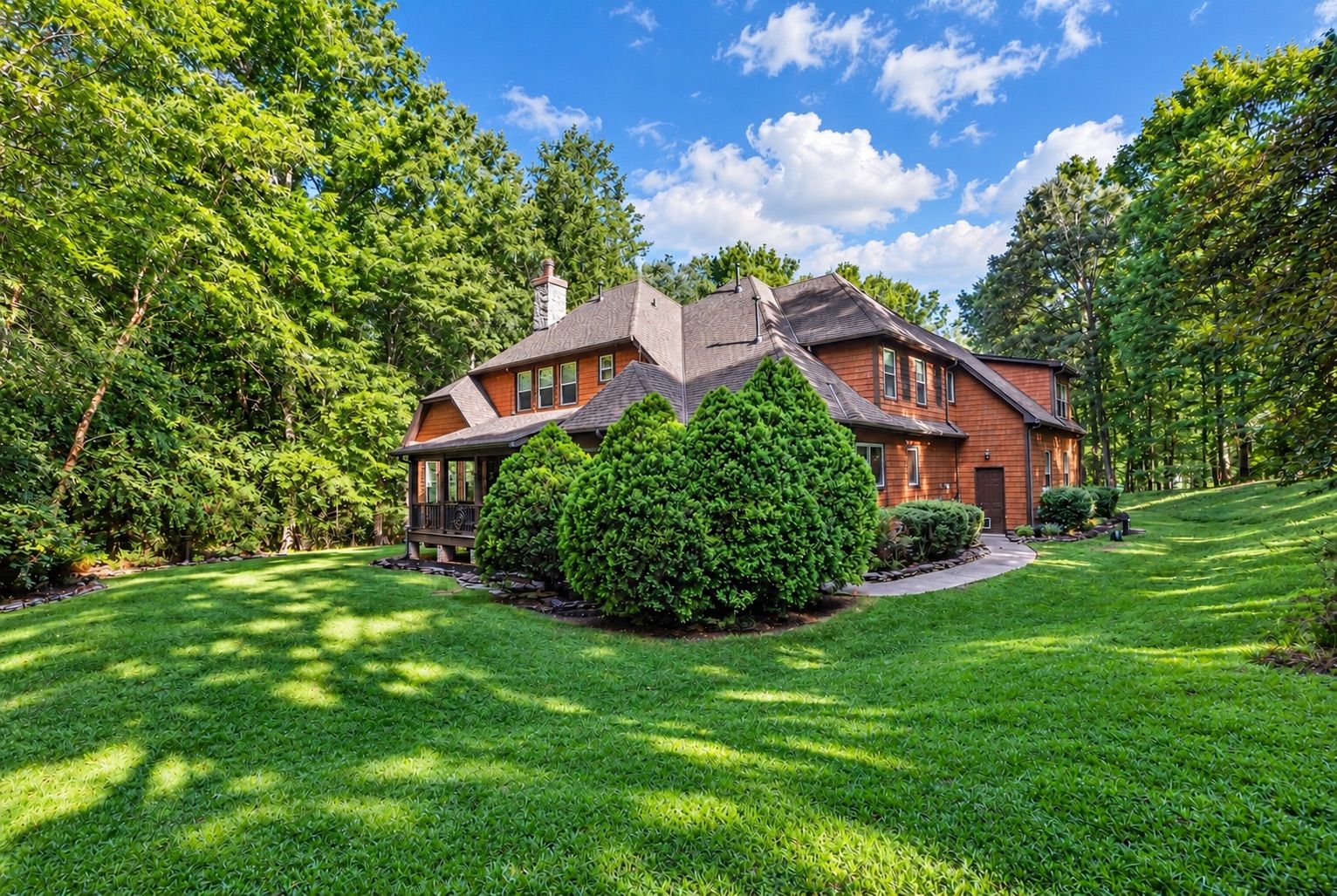 Home set back on a wooded lot with a wide lawn