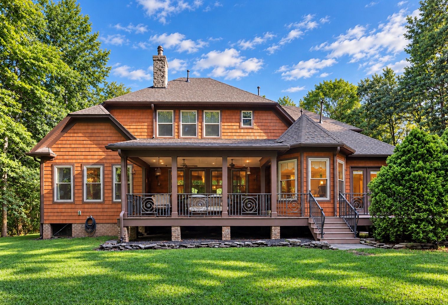 Rear exterior with screened porch and green lawn
