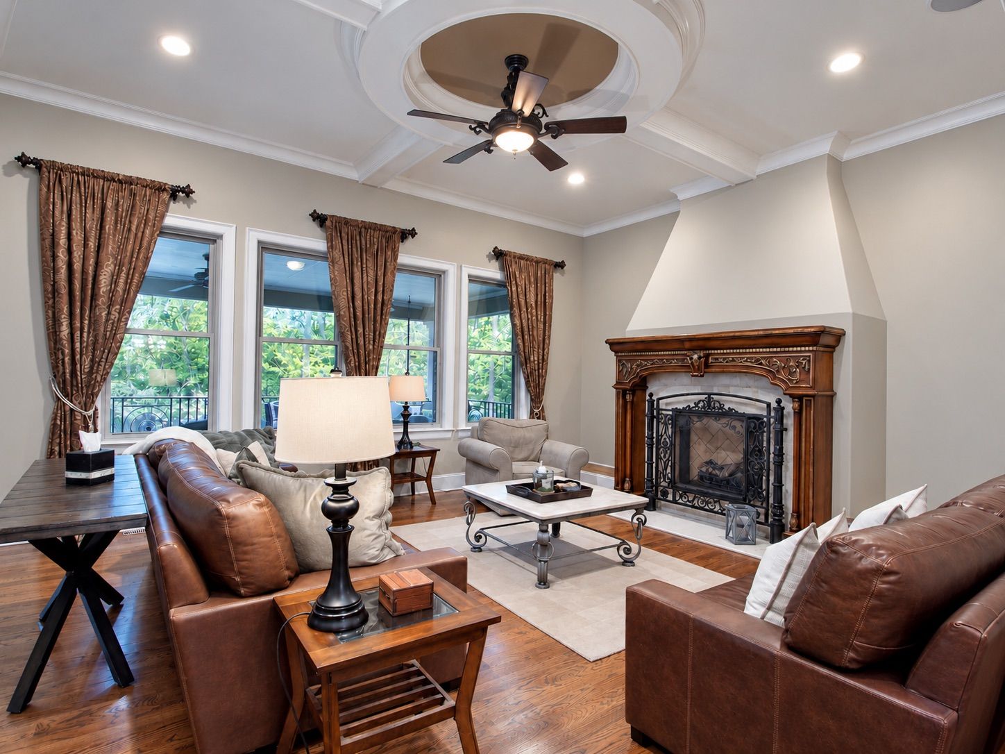 Living room with carved fireplace and leather seating