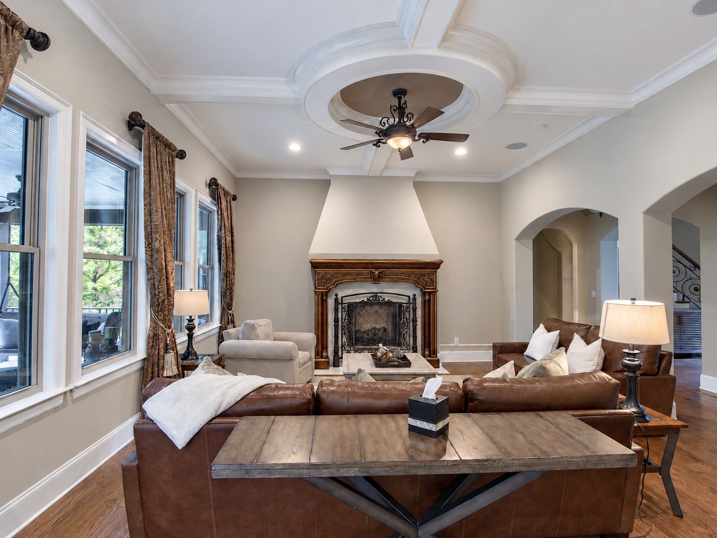 Living room with fireplace, arched openings and rustic coffee table