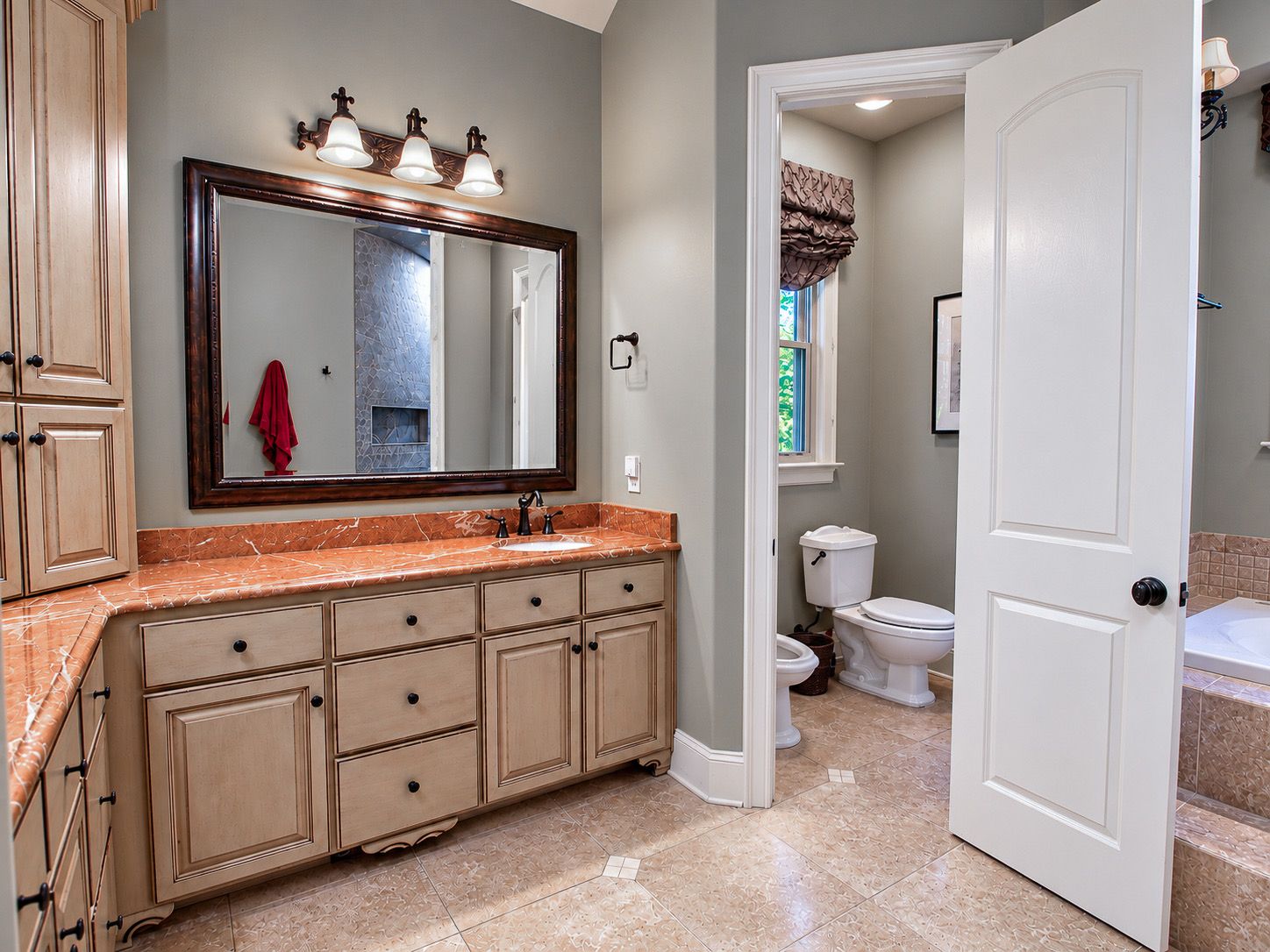 Bathroom vanity with framed mirror and granite counter